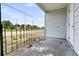 A well-lit porch features a black metal railing offering a view of the neighborhood street and distant trees at 2373 Sorentrue Ave, North Charleston, SC 29405