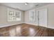 Bright living room featuring hardwood floors, white trim, and natural light streaming through the window at 2373 Sorentrue Ave, North Charleston, SC 29405