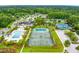 Aerial view of community featuring tennis courts, swimming pool, landscaping and lush foliage at 2402 Brackish Dr, Mount Pleasant, SC 29466