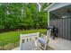 Relaxing back patio with outdoor seating and a grill, offering a serene view of the lush wooded area at 2402 Brackish Dr, Mount Pleasant, SC 29466