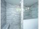 Bathroom with large tiled shower, glass enclosure, and stone mosaic flooring at 2402 Brackish Dr, Mount Pleasant, SC 29466
