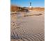 Scenic view of a sandy beach leading to a distant lighthouse, with clear blue skies above at 2402 Brackish Dr, Mount Pleasant, SC 29466