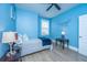 This light blue bedroom has a window, bed, ceiling fan, bedside tables, and minimalist artwork at 2402 Brackish Dr, Mount Pleasant, SC 29466