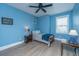 This bedroom features light blue walls, a ceiling fan, and a twin bed with a wooden frame at 2402 Brackish Dr, Mount Pleasant, SC 29466