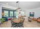 Open-concept dining area with a rustic wooden table and bright natural light at 2402 Brackish Dr, Mount Pleasant, SC 29466