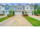 Charming townhomes with varied facades, each featuring a private garage and beautifully landscaped front yards at 2402 Brackish Dr, Mount Pleasant, SC 29466
