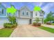 Charming townhomes feature colorful designs with individual garages and meticulously maintained landscaping at 2402 Brackish Dr, Mount Pleasant, SC 29466