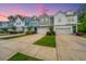 Charming townhomes featuring a colorful mix of exterior materials, garage and driveway at 2402 Brackish Dr, Mount Pleasant, SC 29466