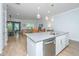Open kitchen overlooking the living area with stainless steel appliances, large island, and stylish pendant lights at 2402 Brackish Dr, Mount Pleasant, SC 29466