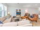 Comfortable living room with tan sectional sofa, armchairs, and natural light at 2402 Brackish Dr, Mount Pleasant, SC 29466