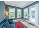 Cozy living room with blue sofa, bright windows and access to the backyard at 2402 Brackish Dr, Mount Pleasant, SC 29466