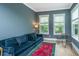 Cozy living room with blue sofa, large windows, and a comfortable seating area at 2402 Brackish Dr, Mount Pleasant, SC 29466