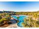 Aerial view of a community pool with a slide and lounge chairs, surrounded by palm trees and lush landscaping at 2402 Brackish Dr, Mount Pleasant, SC 29466