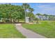 Inviting community space featuring a walking path, fire pit, and seating, ideal for gatherings and relaxation at 2931 Waterleaf Rd, Johns Island, SC 29455