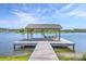 Picturesque dock with seating area offers a tranquil waterfront retreat and beautiful lake views at 2931 Waterleaf Rd, Johns Island, SC 29455