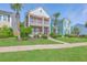 Inviting two-story brick home features double balconies, mature landscaping, and neighborhood charm at 2931 Waterleaf Rd, Johns Island, SC 29455