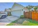 Two-car garage, private fenced yard with a car parked in the driveway at 2931 Waterleaf Rd, Johns Island, SC 29455