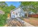 Single-car garage with white siding and a pedestrian door nestled in a fenced yard at 2931 Waterleaf Rd, Johns Island, SC 29455