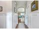 Bright hallway with wood floors and board and batten, leading to the living area at 2931 Waterleaf Rd, Johns Island, SC 29455