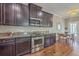 Well-equipped kitchen featuring stainless steel appliances, granite countertops, and dark wood cabinetry at 2931 Waterleaf Rd, Johns Island, SC 29455