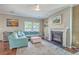 Comfortable living room featuring a ceiling fan, fireplace, and lots of natural light at 2931 Waterleaf Rd, Johns Island, SC 29455