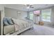 Cozy bedroom with a ceiling fan, television, and natural light from two windows at 2931 Waterleaf Rd, Johns Island, SC 29455