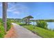 Pathway to a gazebo with canoes and kayaks with pond views and lush landscaping at 2931 Waterleaf Rd, Johns Island, SC 29455