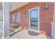 Cozy front porch with brick accents, outdoor seating, and inviting entrance at 2931 Waterleaf Rd, Johns Island, SC 29455