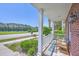 Charming porch view featuring bench seating, brick siding, and scenic neighborhood view at 2931 Waterleaf Rd, Johns Island, SC 29455
