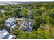 An aerial view of a coastal home with a pool surrounded by lush trees, a neighborhood, and a bridge in the distance at 301 Center St, Mount Pleasant, SC 29464