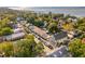 Aerial view showcases charming neighborhood with tree-lined streets, diverse architectural styles, and water views in the distance at 301 Center St, Mount Pleasant, SC 29464