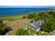 Aerial view of a building near the ocean with a marshy landscape, marina, and pier in the background at 301 Center St, Mount Pleasant, SC 29464