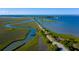 Aerial view of coastal road surrounded by marsh and ocean, leading to an island community at 301 Center St, Mount Pleasant, SC 29464