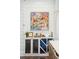 Stylish built-in bar area with custom cabinets, wine storage, decorative glassware, and a colorful painting at 301 Center St, Mount Pleasant, SC 29464