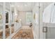 Bright bathroom showcasing double sink vanities, a decorative rug, and a glass walk-in shower at 301 Center St, Mount Pleasant, SC 29464