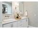 Bright bathroom featuring dual sinks with chrome fixtures and a decorative floral arrangement at 301 Center St, Mount Pleasant, SC 29464