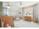 Bedroom with dual cribs, plush decor, and natural light creates a warm, inviting space at 301 Center St, Mount Pleasant, SC 29464