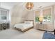 Bedroom with decorative light fixture, neutral walls, and two windows at 301 Center St, Mount Pleasant, SC 29464