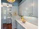 Stylish butler's pantry with custom cabinets, stone countertops, and decorative wall plates at 301 Center St, Mount Pleasant, SC 29464