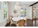 Bright dining area featuring a round table, wicker chairs, elegant lighting, and views of the outdoor patio at 301 Center St, Mount Pleasant, SC 29464