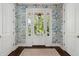 Elegant entryway with beautiful wallpaper, a patterned rug, and classic trim at 301 Center St, Mount Pleasant, SC 29464