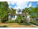 Charming coastal home with a cozy porch, lush landscaping, and a well-manicured lawn at 301 Center St, Mount Pleasant, SC 29464