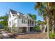Elegant coastal home with a screened porch, garage, and well-maintained landscaping at 301 Center St, Mount Pleasant, SC 29464
