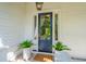 Inviting front entrance featuring a classic blue door and potted ferns at 301 Center St, Mount Pleasant, SC 29464