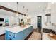 Open kitchen design with a large blue island, white cabinets, wine storage, and modern stainless steel appliances at 301 Center St, Mount Pleasant, SC 29464