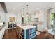 Bright, airy kitchen with white cabinetry, large island with seating, and modern appliances with a connected dining area at 301 Center St, Mount Pleasant, SC 29464