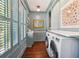 Well-lit laundry room with front-load washer/dryer, folding counter, and built-in storage at 301 Center St, Mount Pleasant, SC 29464