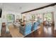 Open-concept living room featuring hardwood floors, shiplap walls, and stylish furnishings that extend to a modern kitchen at 301 Center St, Mount Pleasant, SC 29464