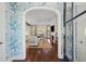 Elegant living room with stylish wallpaper, an open archway, and hardwood floors at 301 Center St, Mount Pleasant, SC 29464