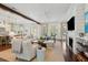 Spacious living room with a fireplace, open floor plan, and plenty of natural light at 301 Center St, Mount Pleasant, SC 29464